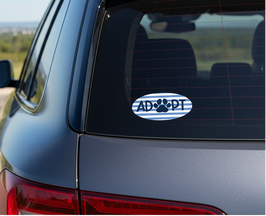 Blue paw print with 'ADOPT' text on a striped blue and white background affixed to the back window of a blue suv